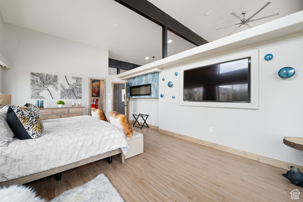 Bedroom with wood finished floors, recessed lighting, and baseboards