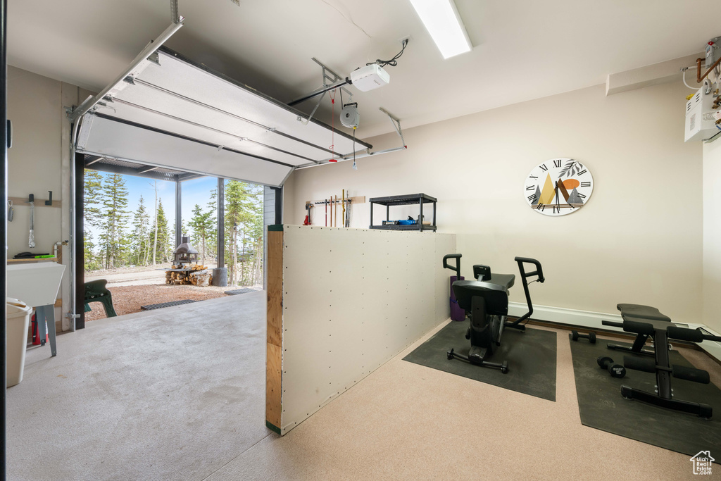 Workout room with carpet flooring and a garage