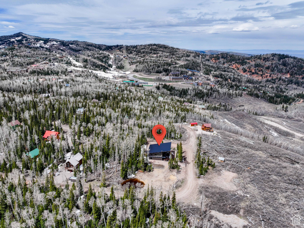 Aerial overview of property's location featuring a mountainous background