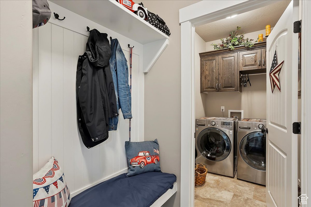 Laundry room with washer and clothes dryer and cabinet space