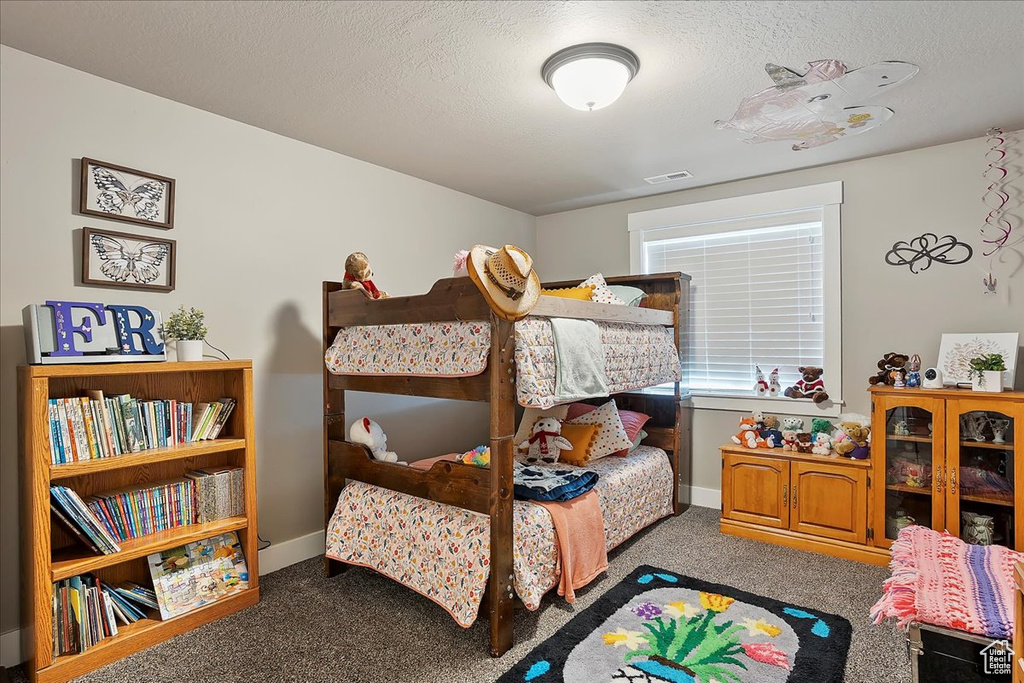 Bedroom featuring carpet flooring and baseboards