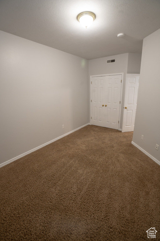 Unfurnished room with baseboards, carpet floors, and a smoke detector