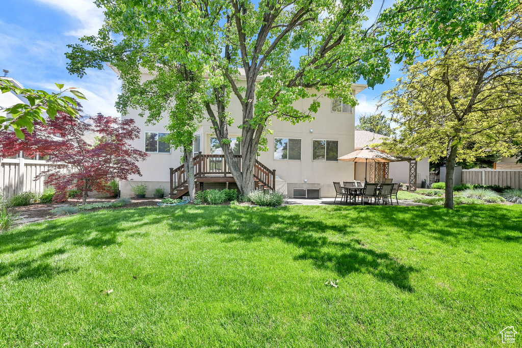 Rear view of property with stucco siding and a patio area