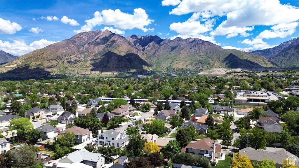 Aerial overview of property's location featuring a mountainous background and nearby suburban area