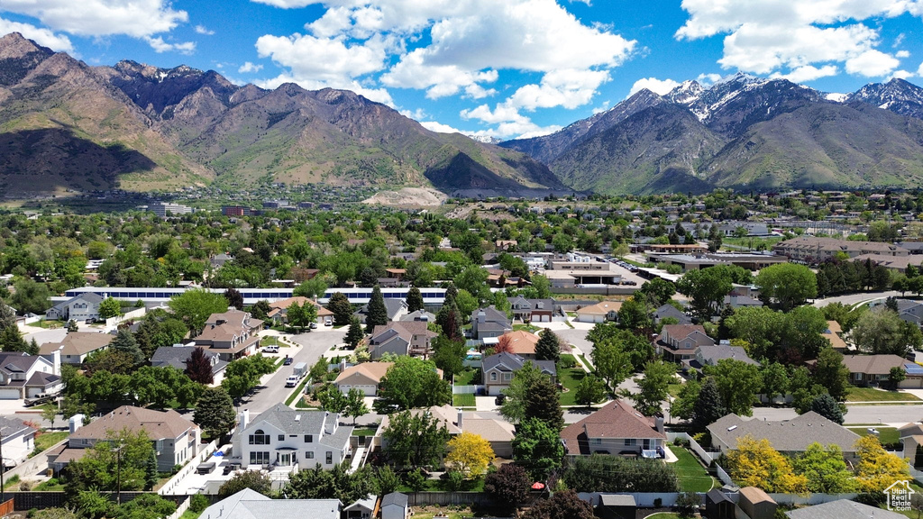 Aerial view of property's location featuring a mountain backdrop and nearby suburban area