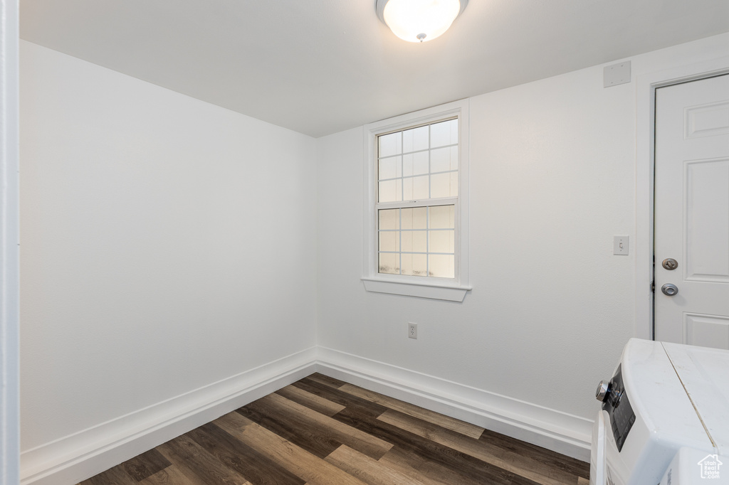 Empty room with dark wood finished floors and baseboards