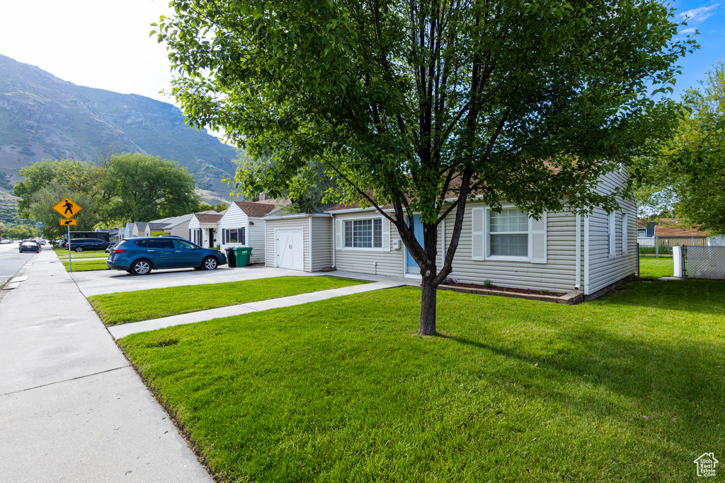 View of front facade with a mountain view and driveway