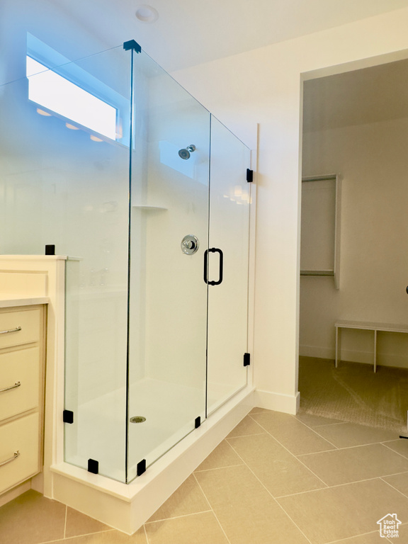 Full bath with tile patterned floors and a shower stall