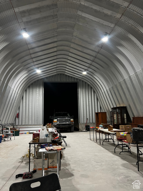 Misc room featuring lofted ceiling and concrete floors