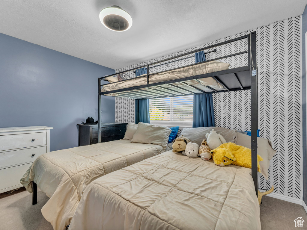 Carpeted bedroom with baseboards