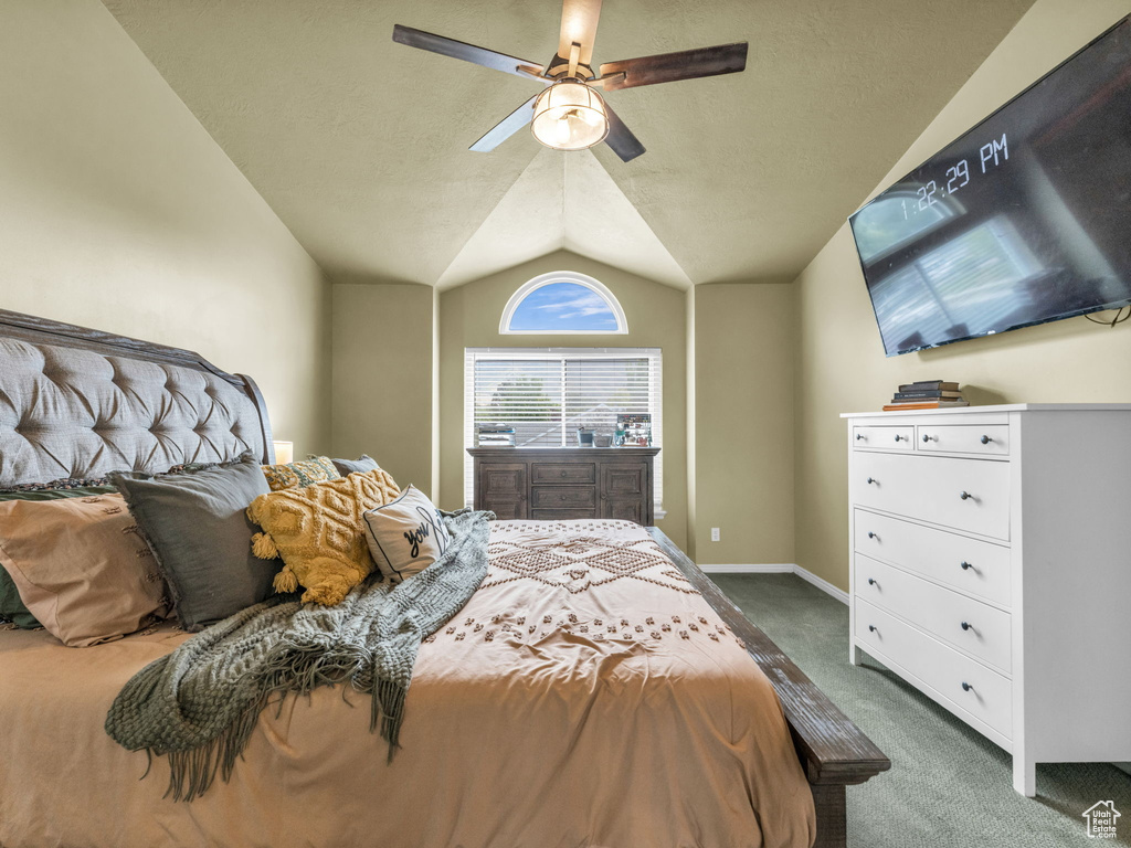 Bedroom with carpet flooring, lofted ceiling, a textured ceiling, ceiling fan, and baseboards