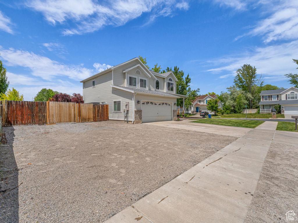 View of property exterior with driveway and an attached garage