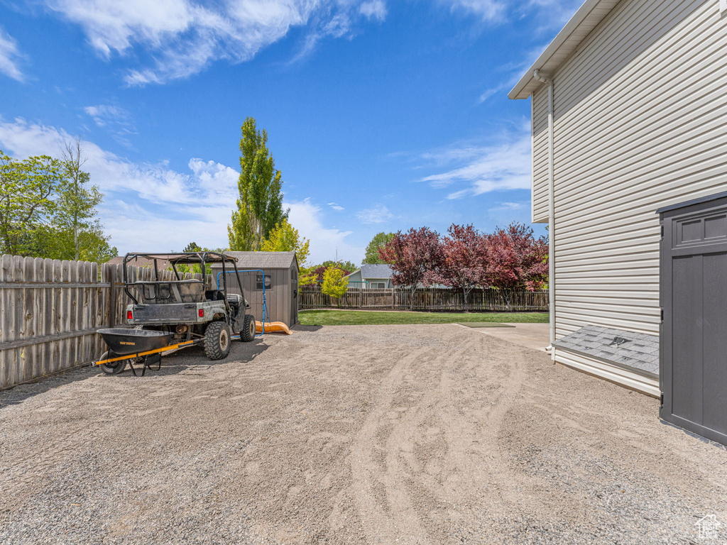 Fenced backyard with an outbuilding