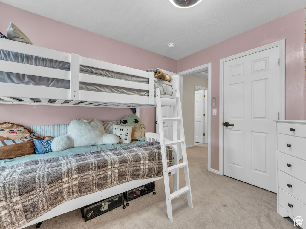 Bedroom with light carpet