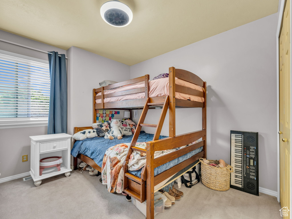 Carpeted bedroom with baseboards and beverage cooler