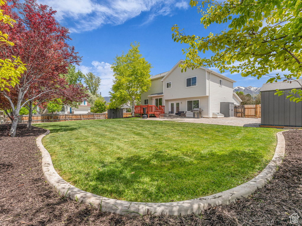 View of yard featuring a patio area and a deck