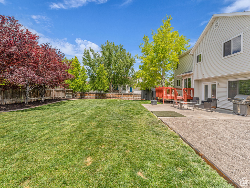 View of yard with a patio and a deck