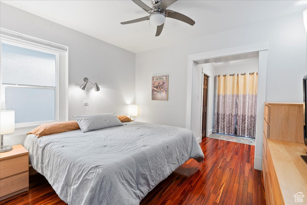 Bedroom with dark wood-type flooring and a ceiling fan