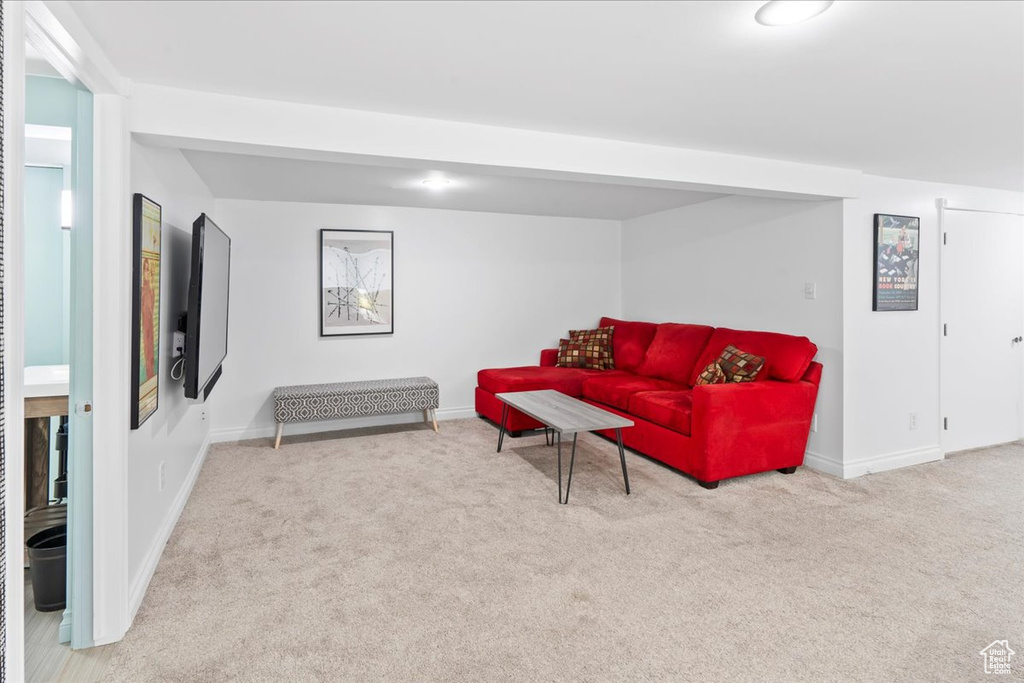 Carpeted living room with baseboards