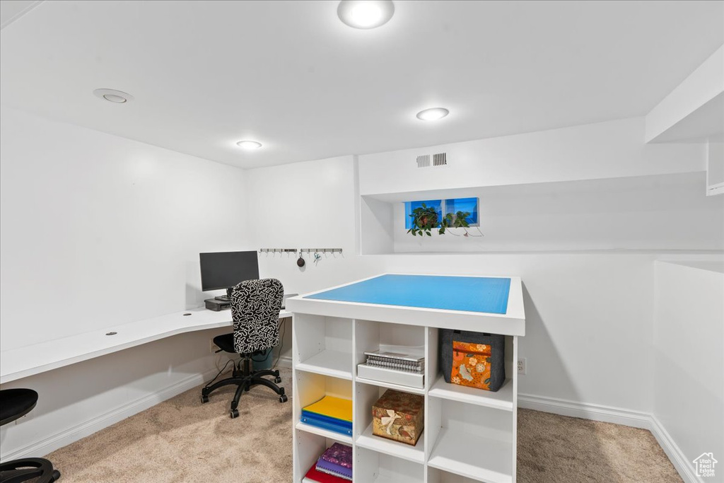 Carpeted office space featuring baseboards