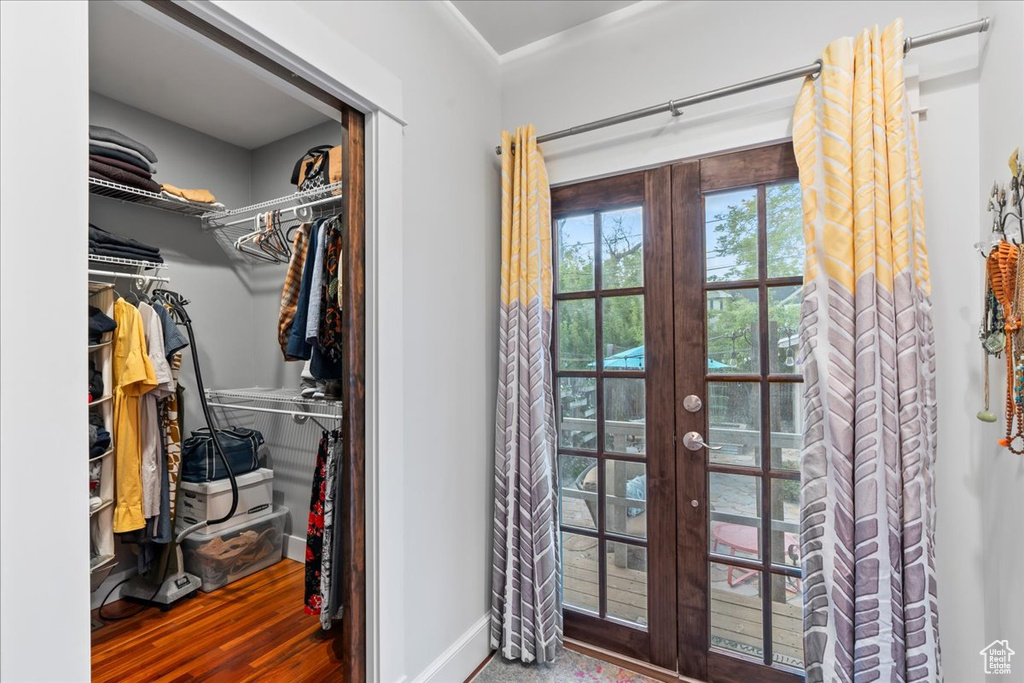 Interior space with french doors, baseboards, and wood finished floors