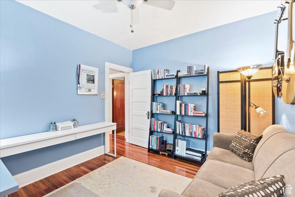 Office area with ceiling fan, wood finished floors, and baseboards
