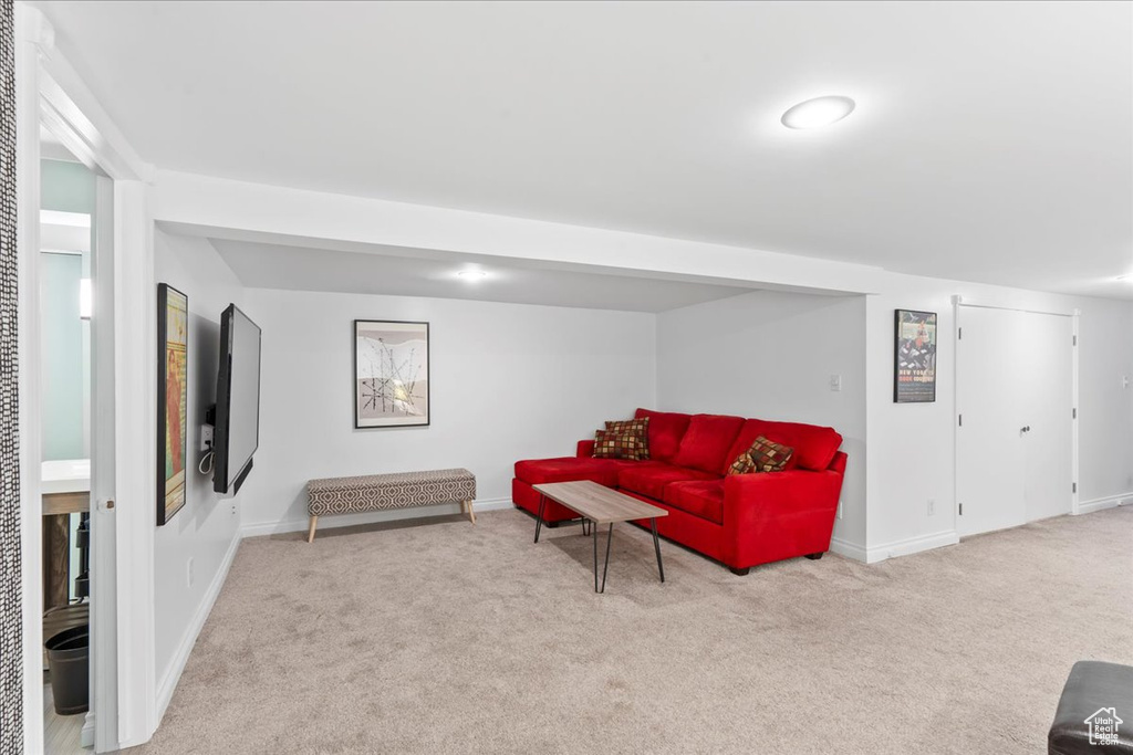 Carpeted living room featuring baseboards