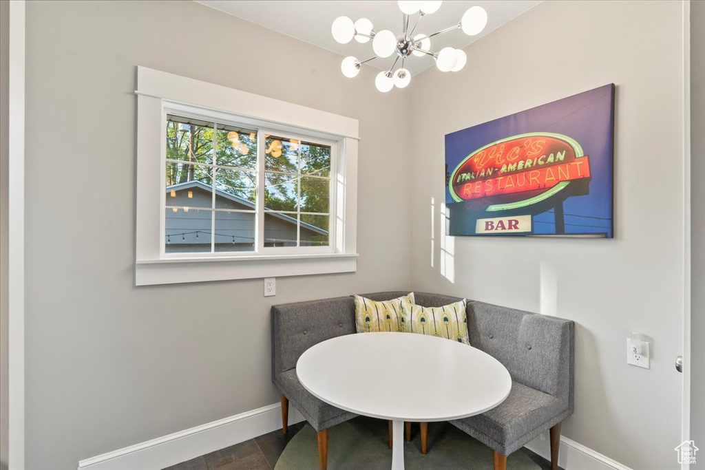 Dining space featuring baseboards and a chandelier