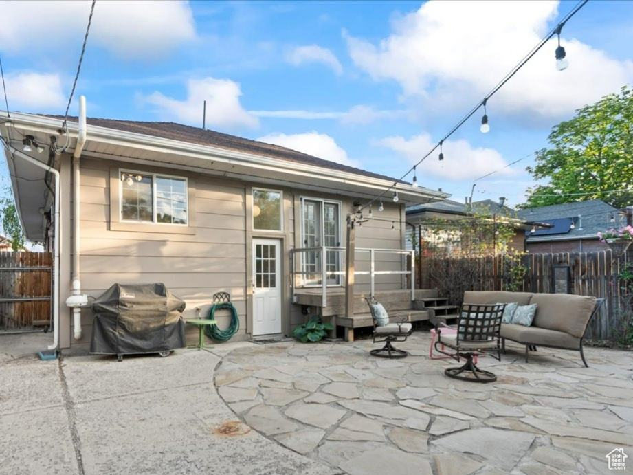 Back of property with a patio area, a fenced backyard, and outdoor lounge area
