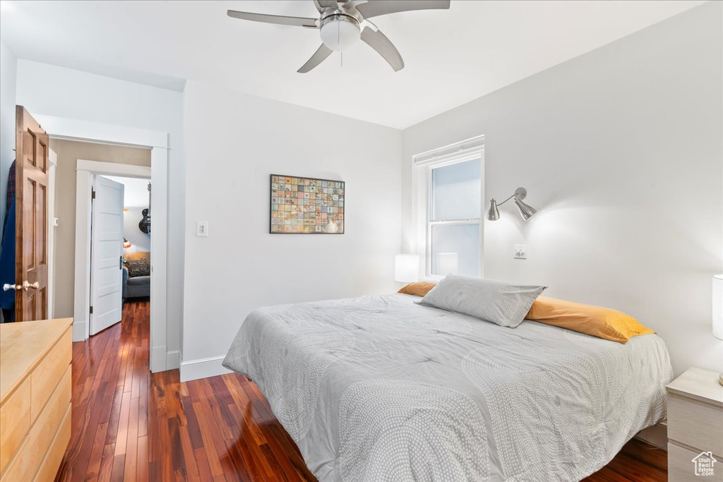Bedroom featuring dark wood finished floors, ceiling fan, and baseboards