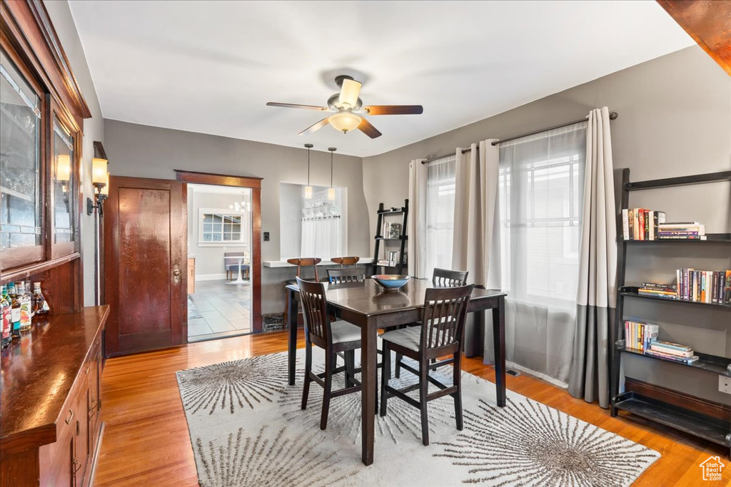 Dining room featuring a ceiling fan, light wood-type flooring, and baseboards