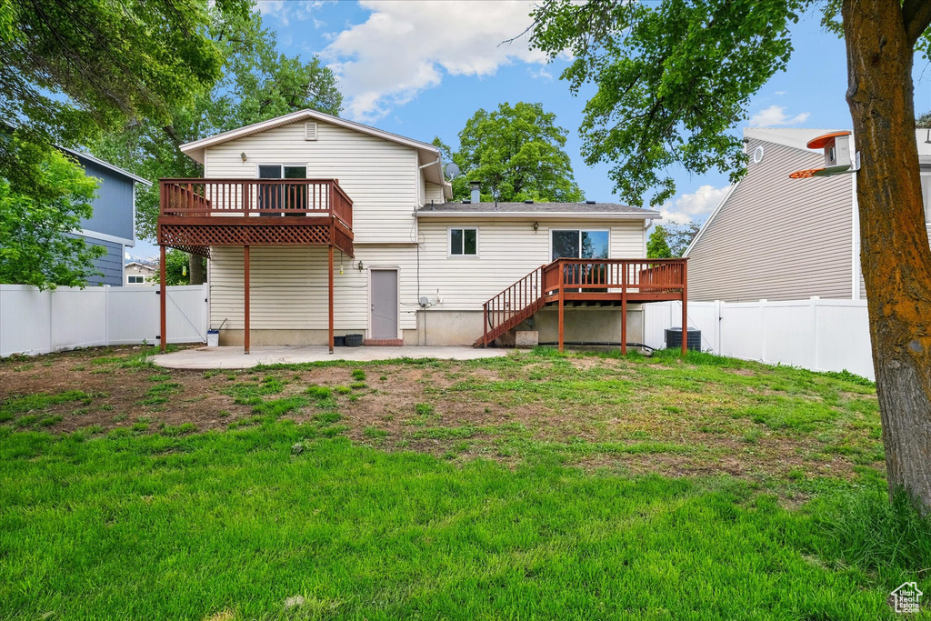 Rear view of house with a deck, a patio, and stairway