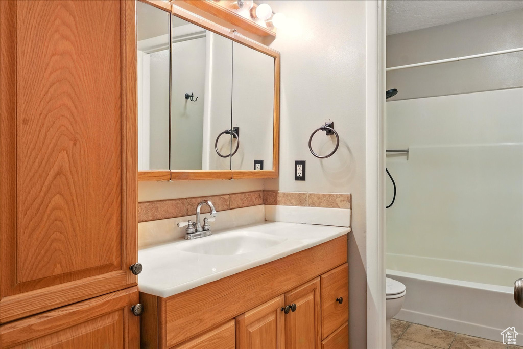 Full bath featuring vanity, toilet, and shower / washtub combination