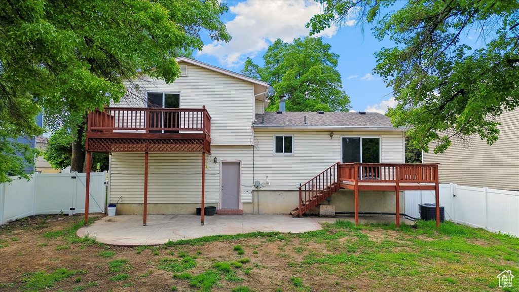 Rear view of property with a gate, a fenced backyard, a patio area, and a wooden deck