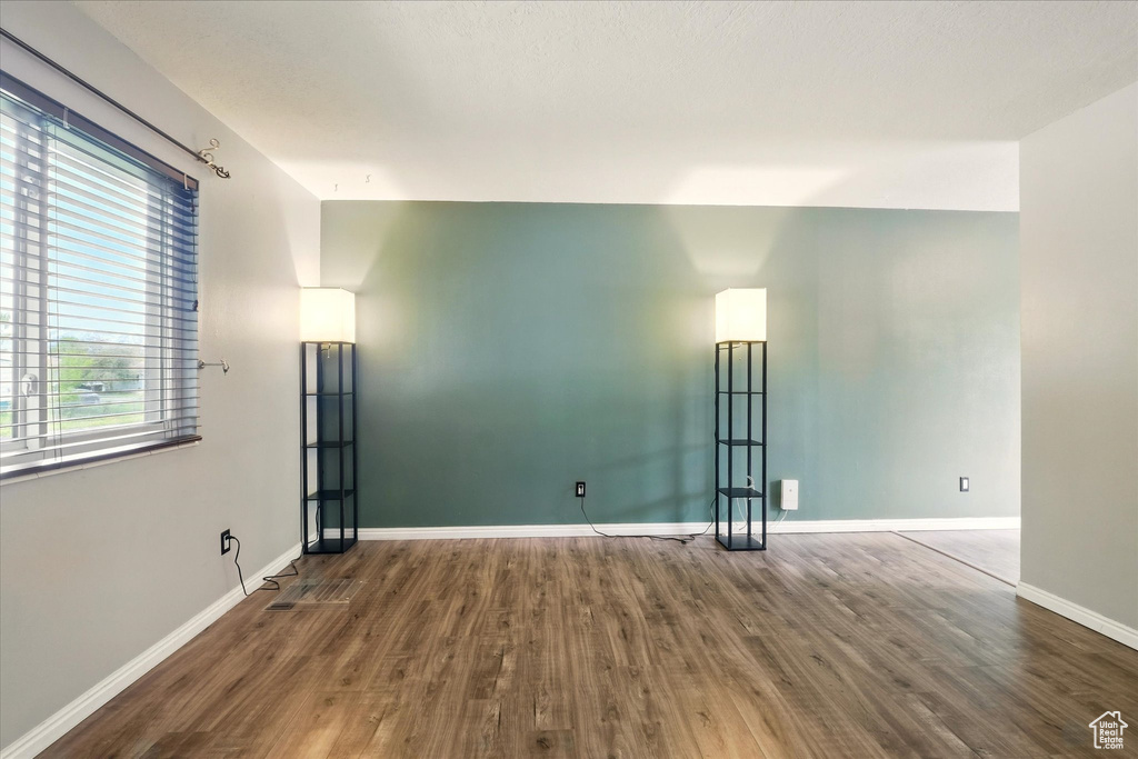 Empty room with wood finished floors and baseboards