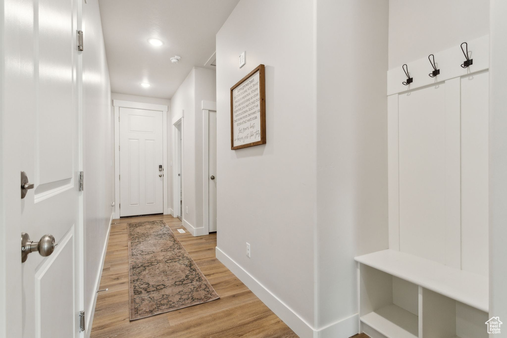 Mudroom featuring light wood-style floors, baseboards, and recessed lighting