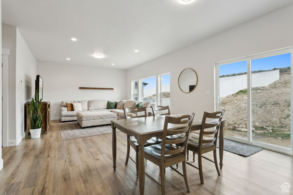 Dining space featuring wood finished floors, recessed lighting, and baseboards