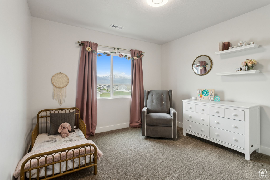 Carpeted bedroom featuring baseboards