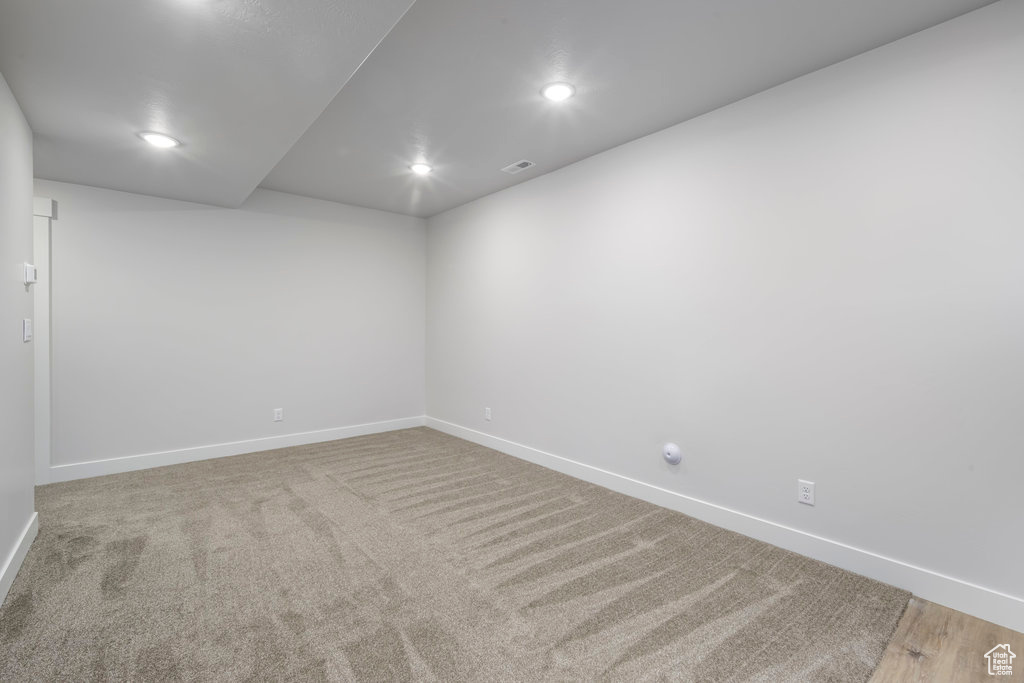 Spare room with baseboards, recessed lighting, and carpet flooring
