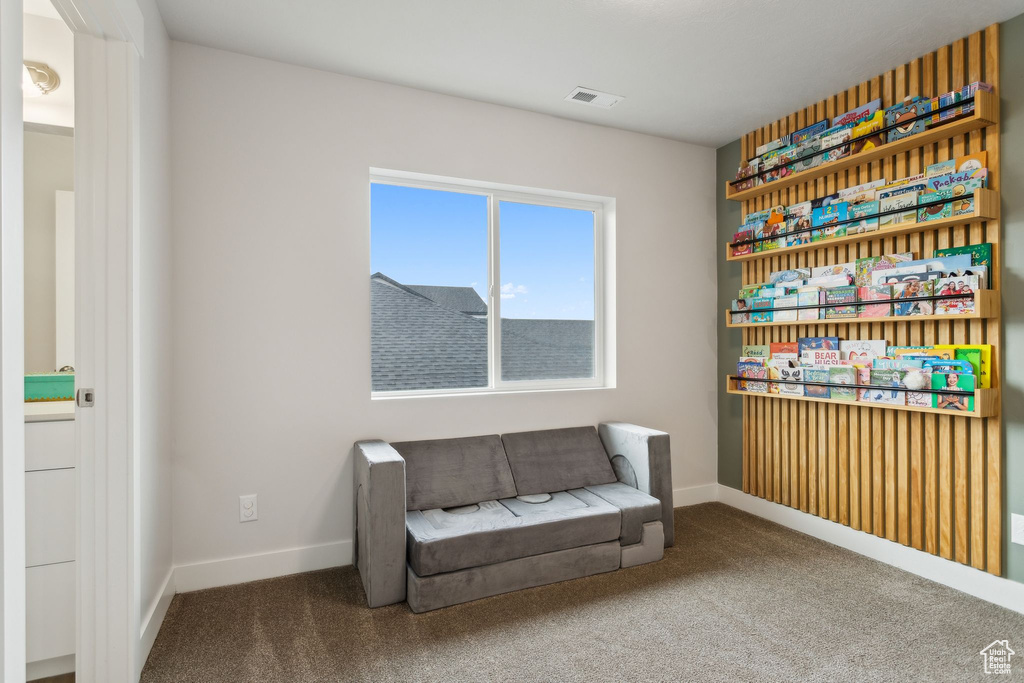 Living area with carpet and baseboards