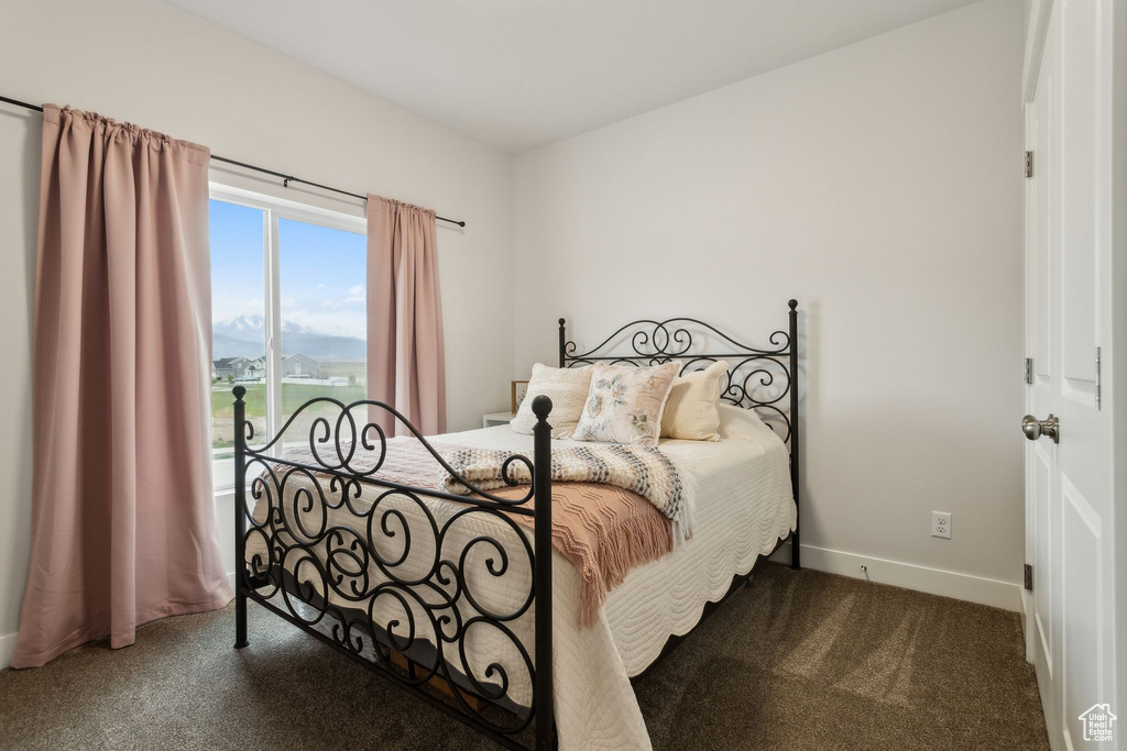 Bedroom featuring carpet floors and baseboards