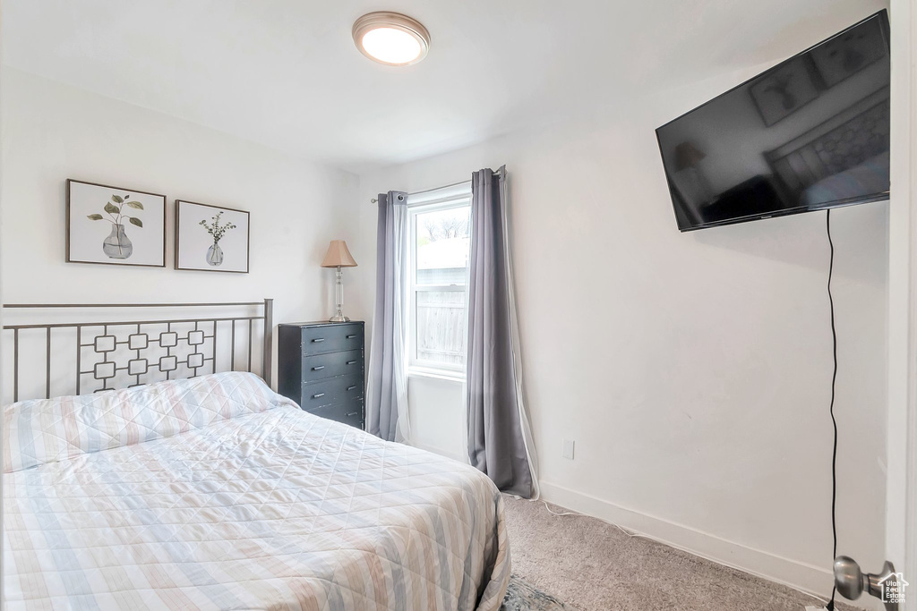 Carpeted bedroom featuring baseboards