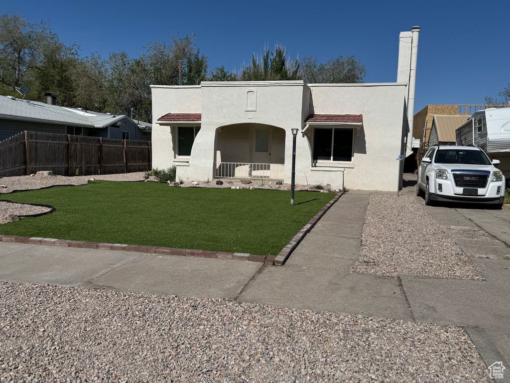 View of front of property featuring a porch and stucco siding