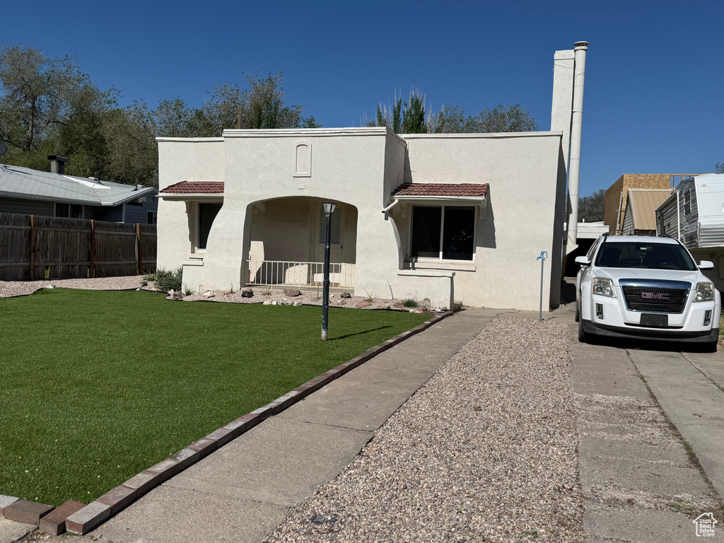Mediterranean / spanish-style home with stucco siding and a porch