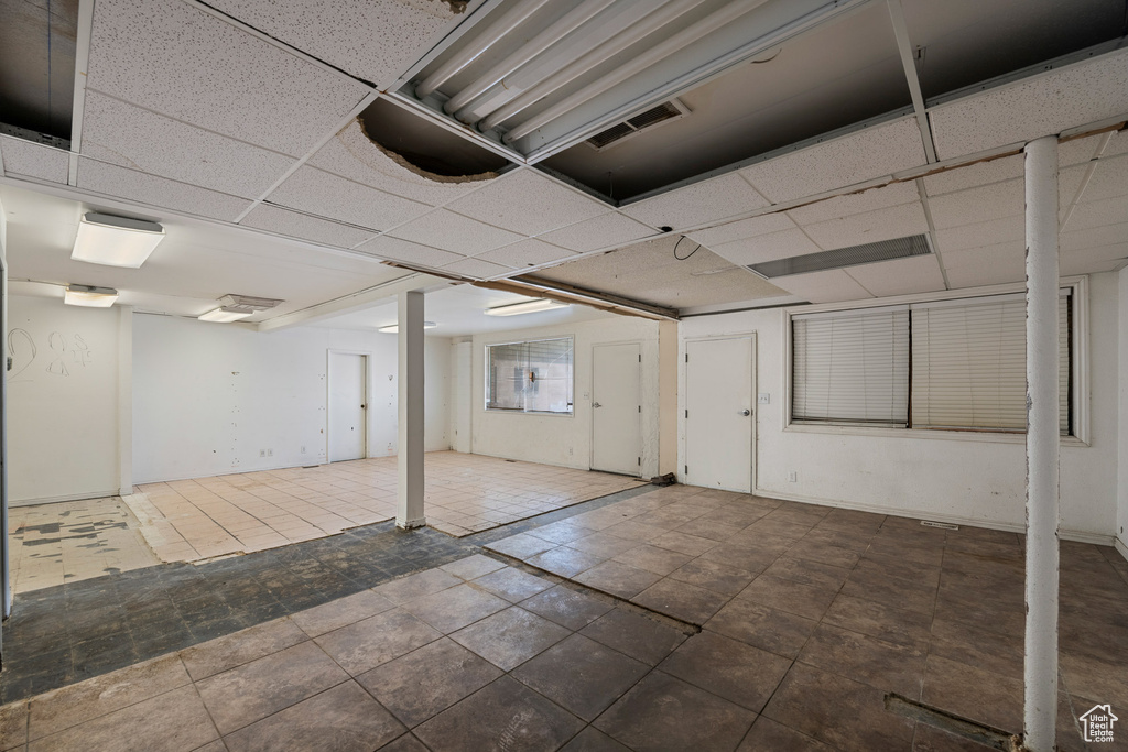 Finished basement featuring a drop ceiling
