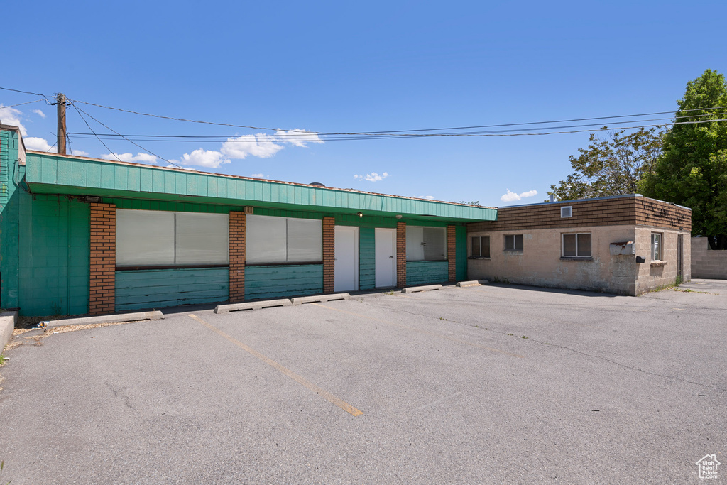 View of building exterior with uncovered parking