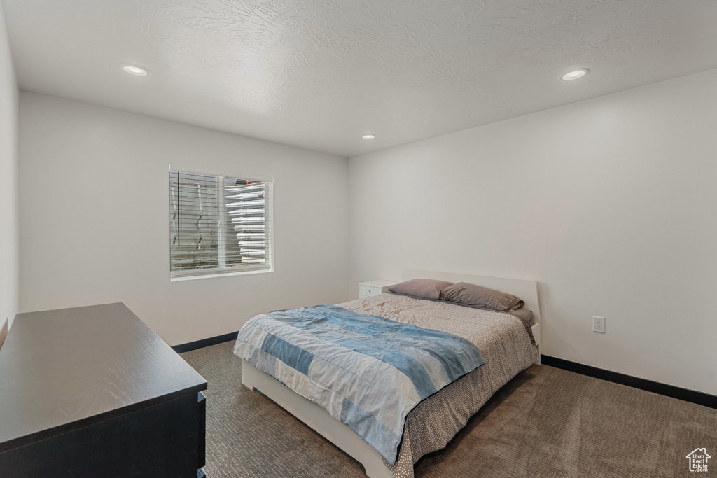 Carpeted bedroom with baseboards and recessed lighting