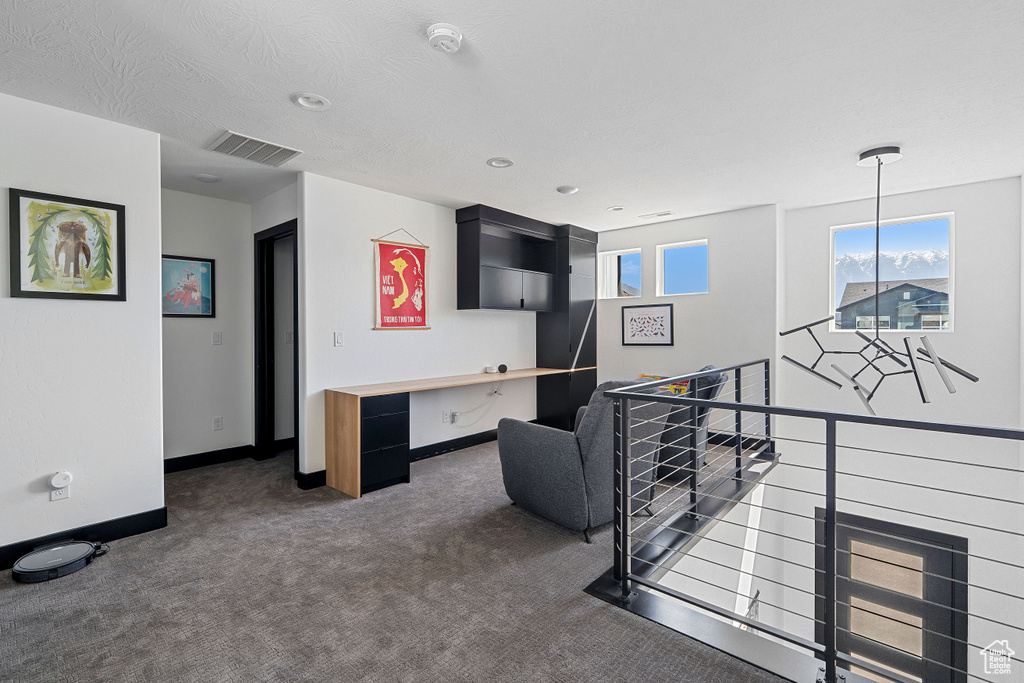 Carpeted living area with baseboards and recessed lighting