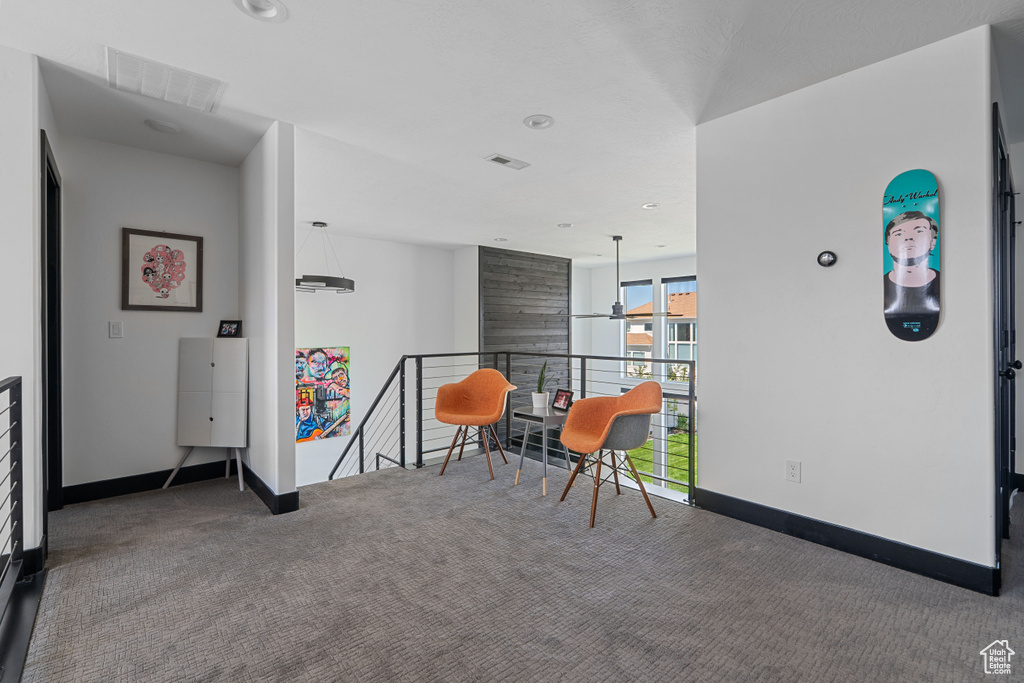 Sitting room with carpet, an upstairs landing, baseboards, and recessed lighting