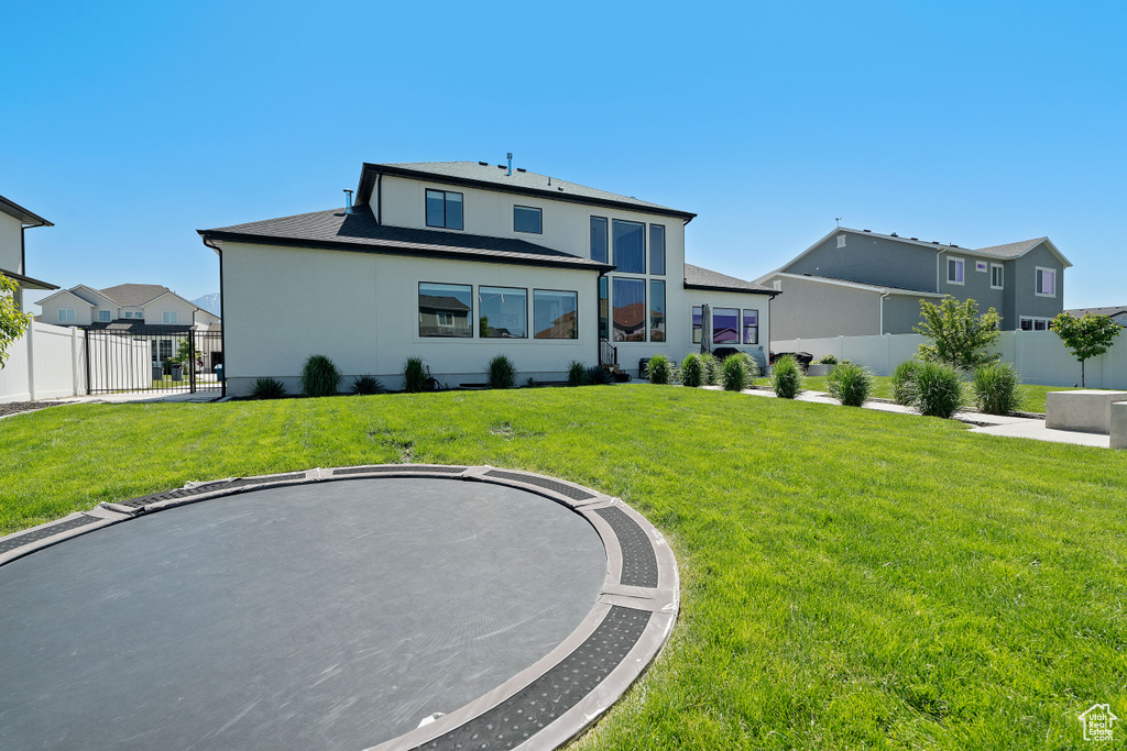 Rear view of property featuring a shingled roof
